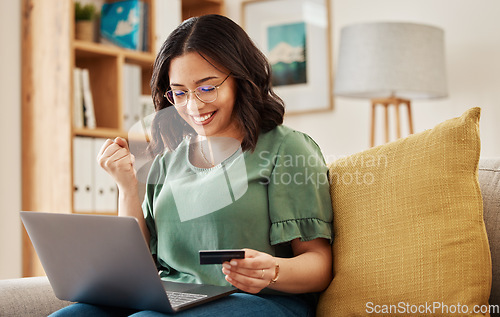 Image of Winning, laptop and credit card, happy woman on sofa in living room for internet banking in home. Ecommerce payment, smile and cashback, girl at computer browsing retail website for online shopping.