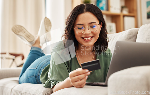 Image of Relax, laptop and credit card, happy woman on sofa in living room for internet banking in home for online shopping. Ecommerce payment, smile and cashback, girl on couch with computer and website sale