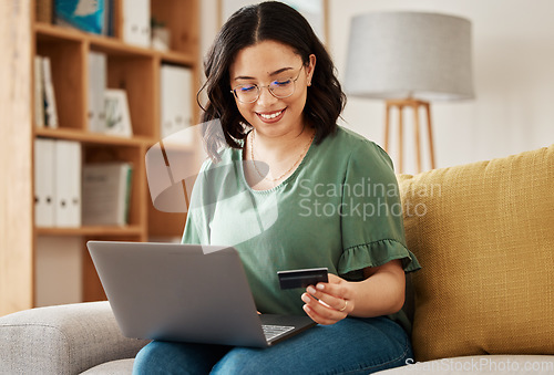 Image of Online shopping, laptop and credit card, woman on sofa in living room for internet banking app in home with tech. Ecommerce payment, smile and cashback, girl at computer browsing retail website sale.