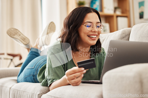 Image of Relax, laptop and credit card, happy woman on couch in living room for internet banking in home for online shopping. Ecommerce payment, smile and cashback, girl on sofa with computer and website sale