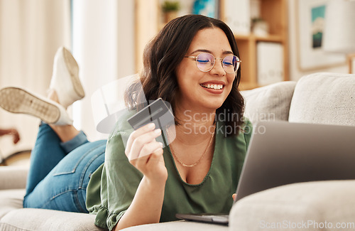 Image of Online shopping, relax and credit card, woman on sofa in living room for internet banking app in home with laptop. Ecommerce payment, smile and cashback, girl at computer browsing retail website sale