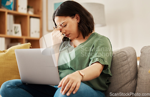 Image of Woman, home and headache with burnout with laptop and remote work stress on sofa feeling frustrated. House, female person and confused from computer problem with anxiety from online website on couch