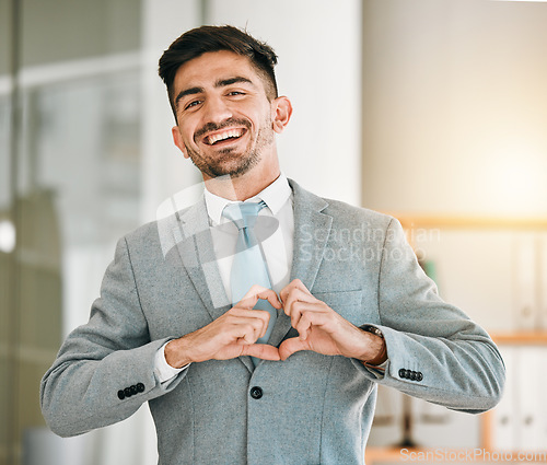 Image of Portrait of businessman, heart hands and smile in office with confidence, opportunity and happiness at startup. Emoji, business and face of happy man with love hand gesture in professional workplace.