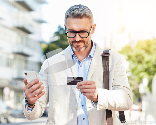 Image of Phone, credit card and businessman travel using online payment for a commute mobile app, online and on the internet. City, corporate and mature professional walking with smartphone for ecommerce