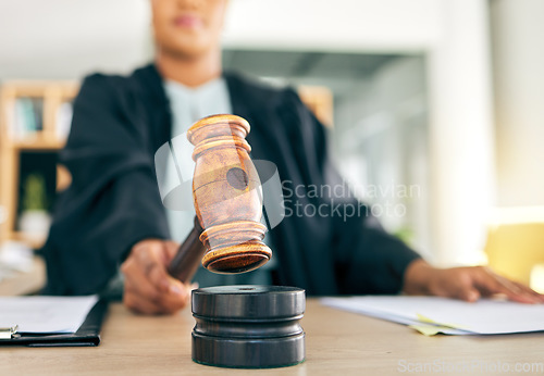 Image of Law, gavel and black woman judge order the court for an investigation of criminal case in a legal firm. Stop, administration and lawyer working on justice or planning policy in an attorney office