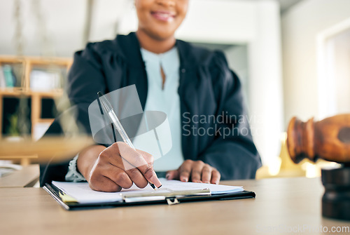 Image of Legal, scale and hands of black woman lawyer writing for an investigation document or criminal case in law firm. Court, administration and judge working on justice or planning in attorney office