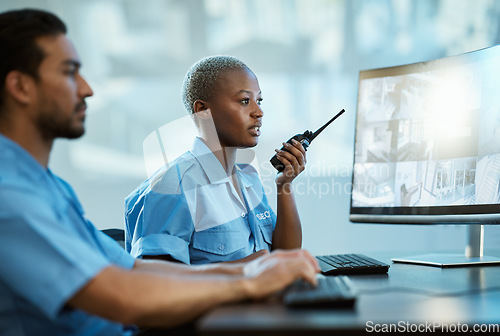 Image of Security guard, safety and control room with a radio and computer monitor for surveillance. Man and woman working together for crime investigation, cctv screen and communication with a walkie talkie