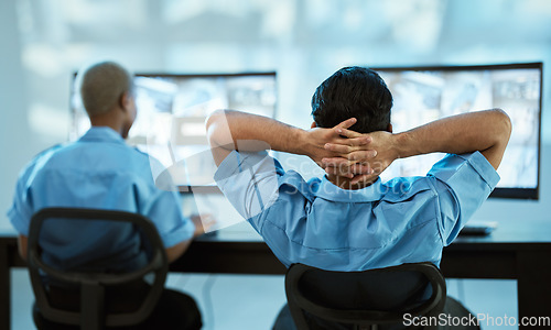 Image of Security guard, safety and team in control room with a computer screen for surveillance. Behind a man and woman officer relax in office for crime investigation with cctv monitor and camera footage