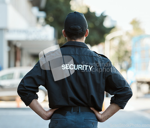 Image of Man, back and security guard in city for safety protection, law enforcement or outdoor emergency. Rear view of male person, police or officer standing ready for crime control to protect and serve