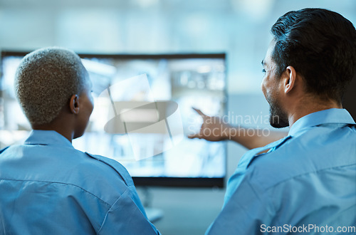 Image of Safety, security guard team and control room with a computer screen for surveillance. Behind a woman and man pointing at cctv monitor for crime investigation, supervision and monitoring live camera