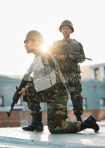 Image of Army, training and people with gun, defense or power on rooftop for aim, shooting or practice. Military, weapon and black woman with man soldier and sniper rifle for war, target or protection team