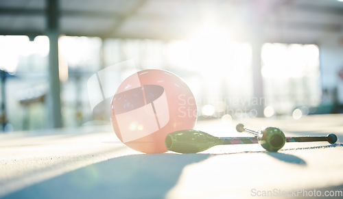 Image of Gymnastics, aerobics and ball on floor in gym for rhythmic movement, training and exercise in studio. Creative performance, fitness and closeup of equipment for competition, sports and dance club