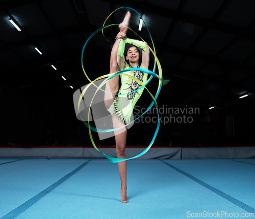 Image of Gymnastics, dance and woman with ribbon in gym for rhythmic movement, training and exercise in studio. Creative performance, sports and portrait of female dancer for competition, workout and dancing