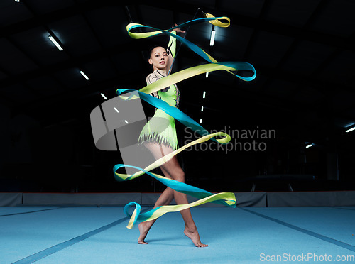 Image of Rhythmic gymnastics, woman in gym and ribbon, creativity and action with performance and fitness. Competition, athlete and female gymnast, dance and art with body, routine and energy at arena