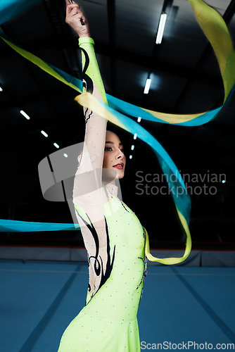 Image of Ribbon, dance and rhythmic gymnastics, woman in gym with action and performance for fitness. Competition, athlete and female gymnast, dancer with creativity and art, routine and energy at arena