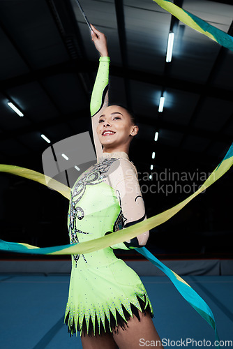 Image of Happy, woman and rhythmic gymnastics with ribbon in gym, creativity and action, performance and fitness. Competition, athlete and female gymnast, dance and art with body, routine and energy at arena