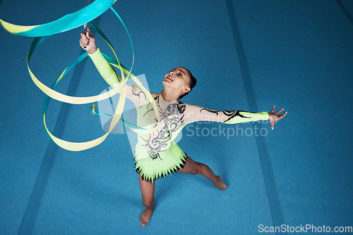 Image of Dance, rhythmic gymnastics and woman in gym with ribbon in air, action with performance top view and fitness. Competition, athlete and female gymnast, creativity and art, routine and energy at arena