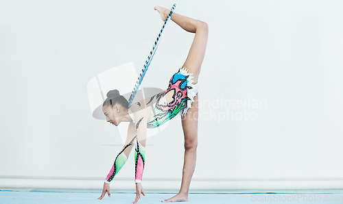 Image of Woman, balance and gymnastics competition, performance and body in arena with leg in air. Female gymnast, event and athlete exercise, flexibility and health for sports, fitness and acrobat in gym