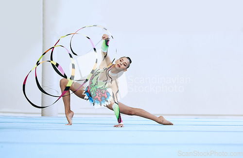 Image of Gymnastics woman, ribbon and floor in portrait, competition or sport for fitness, performance or studio. Gymnast, athlete girl and professional dancer with balance, exercise or contest for creativity