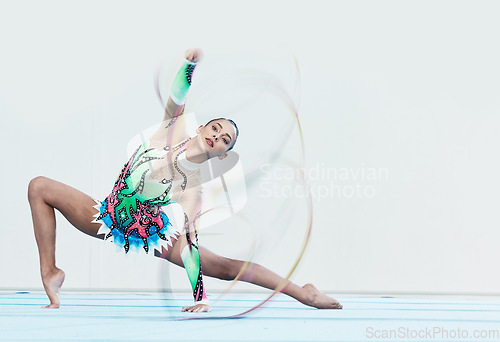 Image of Gymnastics performance, woman and ribbon in portrait for competition, sport or fitness on studio floor. Gymnast, athlete girl and professional dancer with balance, training or contest with creativity