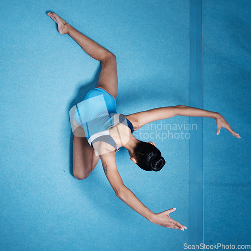 Image of Woman, gymnast and athlete stretching, workout routine and performance with mockup space. Female person in gymnastics exercise and flexibility with health and sports in gym, training and top view