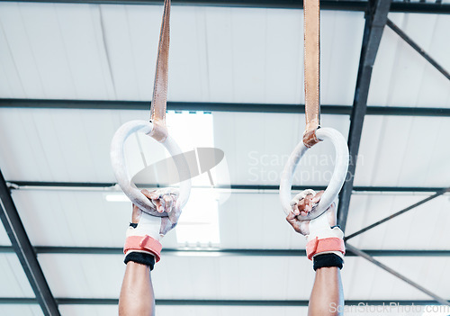 Image of Hands, gymnastics ring and person in fitness for workout, strength training or competition. Closeup of hanging athlete, strong gymnast or acrobat holding on balance circles for performance exercise