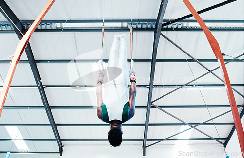 Image of Gymnastics, rings and man at gym for fitness, workout and body, performance or training. Balance, exercise and guy acrobat at sports studio for athletics, resilience and cardio, hanging or endurance