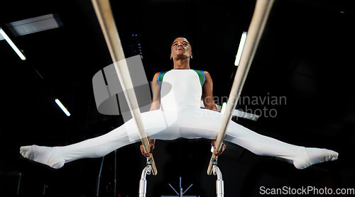 Image of Gymnastics, bars and man at gym for fitness, workout and body, performance or training. Balance, exercise and guy acrobat at sports studio for athletics, resilience and cardio, beams or endurance