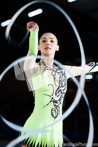 Image of Gymnastics, dance performance and woman with ribbon for rhythmic movement, training and exercise. Aerobics practice, sports and female person in action for competition, workout and creative dancing