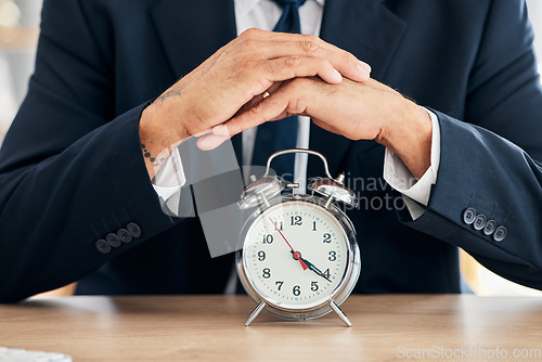 Image of Clock, business man and time management in office for deadline, punctual and busy schedule. Hands of professional person or broker working at desk with alarm, reminder and timer for goals and agenda