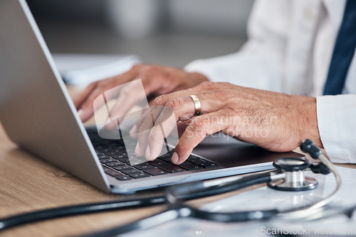 Image of Doctor, hands and laptop for healthcare research, hospital management and admin or planning and clinic information. Medical professional working or typing on computer for telehealth services and FAQ