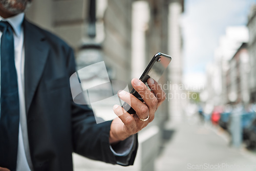 Image of Hands, phone and travel with a business man in the city using an app for location, navigation or direction. Mobile, commute and communication with a male employee typing a message in an urban town