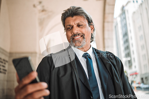 Image of Phone, app and a senior man judge at court, outdoor in the city during recess from a legal case or trial. Smile, mobile and communication with a confident magistrate in an urban town to practice law