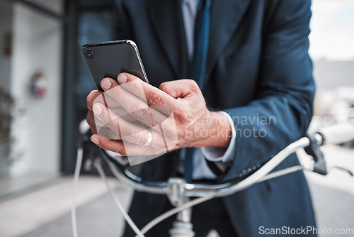 Image of Phone, typing and hands of businessman with bicycle for travel, transport or directions to office, building or work in the city. Man, search and connection to internet with bike for journey in town