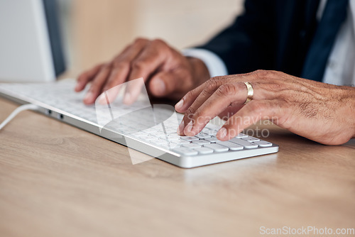 Image of Hands, keyboard and a business man typing while working on a computer in his office for management. Email, desk and administration with a male employee at work to draft a proposal or feedback report