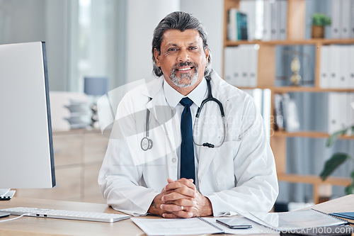 Image of Doctor, portrait and man in healthcare office for consultation, support and services or advice at table. Happy face of medical worker or senior person with health insurance in clinic or hospital