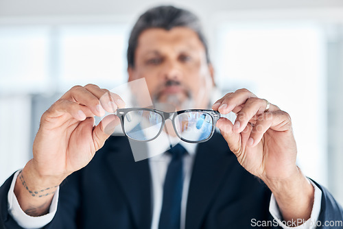 Image of Man, hands and holding glasses at work for vision, bluelight security and cleaning lens. Closeup, bokeh and a mature corporate employee with eyewear for eyes support, frame and help with eye care