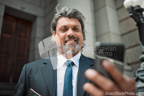 Image of Happy man, social media or lawyer with phone for news, legal services update or networking online. Smile, mature advocate or senior judge typing on website to scroll, chat or search outside a court