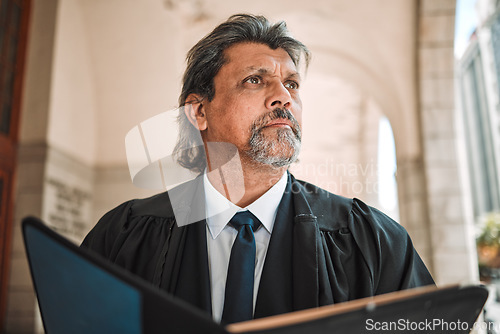 Image of Thinking, book and a senior man judge at court, outdoor in the city during recess from a legal case or trial. Idea, authority and power with a confident magistrate in an urban town to practice law