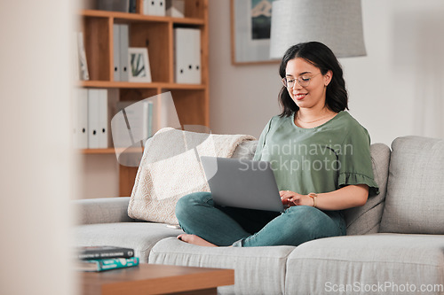 Image of Happy woman, remote work and laptop on sofa in home for digital planning, online research or blog info. Female freelancer working on computer, technology and website media for telework in living room