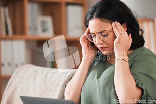 Image of Stress, headache and woman in her living room working on a deadline project on a laptop for remote job. Burnout, migraine and young female creative freelancer doing research on computer in apartment.