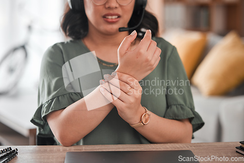 Image of Woman, hands and wrist pain in remote work from injury, typing or overworked by desk at home office. Closeup of female person or call center consultant with sore ache, joint or carpal tunnel syndrome