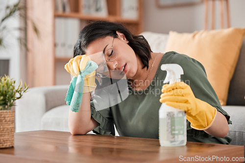 Image of Tired woman, housekeeper and headache with detergent for cleaning furniture, hygiene or bacterial removal at home. Exhausted female person, cleaner or maid in burnout or overworked from housework