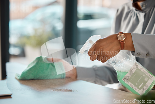 Image of Hands, cleaning and product on a wooden table for hygiene, disinfection or to sanitize a surface in a home. Gloves, bacteria and spray with a woman cleaner in the living room for housework or chores