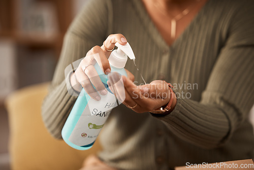 Image of Closeup, hands and a person with sanitizer for medical safety and security from virus in a house. Alcohol, clean and a woman with a bottle of disinfectant liquid in palm for healthcare while sick