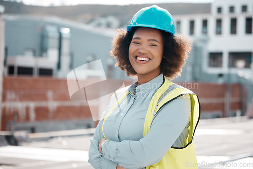 Image of Portrait, engineer and woman with arms crossed in city for career in renewable energy on rooftop. Face, architect and confident developer, solar contractor or happy worker from South Africa outdoor