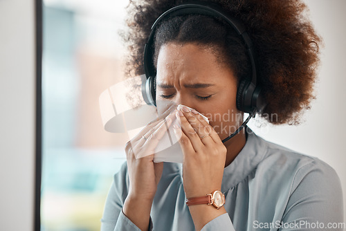 Image of Consultant, sick woman and blowing nose in office for flu, allergies, and health risk in telemarketing agency. Face of female sales agent, call centre and tissue for virus, allergy and sneeze