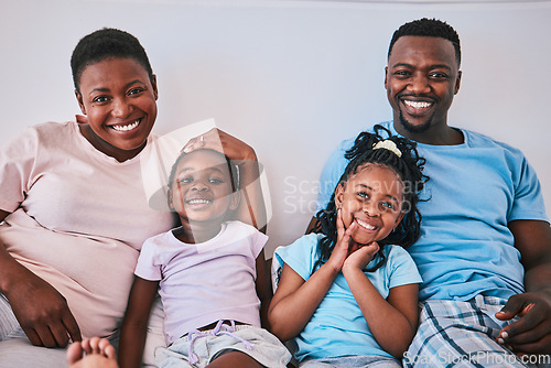 Image of Black family, happy and portrait in a bed with smile, care and comfort on the weekend in their home. Face, love and children with parents in bedroom rest, embrace and relax in the morning together