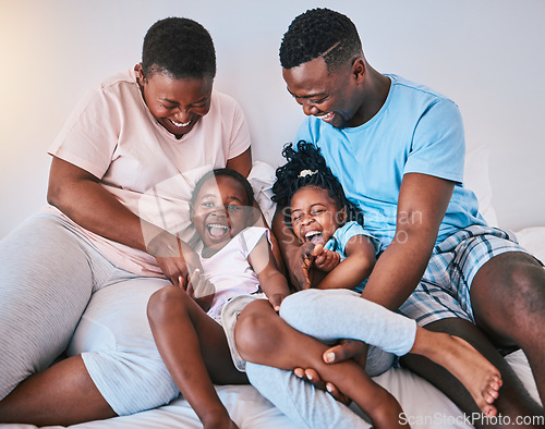 Image of Happy, laugh and black family on a bed with games, tickle and bonding in a home on the weekend. Love, playing and children with parents in a bedroom, playful and having fun in the morning a house