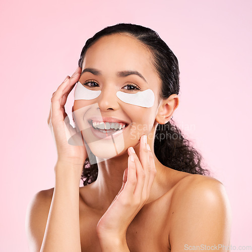Image of Face mask, eye patch and beauty of a woman with natural skin glow on a pink background. Dermatology, collagen and cosmetics portrait of female model for facial shine, wellness or self care in studio